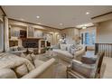 Elegant living room with a cozy fireplace, neutral tones, and ample seating arrangement at 2988 Rockbridge Dr, Highlands Ranch, CO 80129