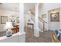 Bright dining room with hardwood floors, chandelier, and views to the living room at 11261 W Quincy Pl, Littleton, CO 80127