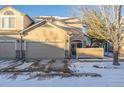 Attached two-car garage with ample parking space and snowy driveway at 11261 W Quincy Pl, Littleton, CO 80127