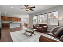 Open-concept living room, hardwood floors, with comfortable seating, and seamless access to the kitchen and dining area at 3980 Trail Stone Cir, Castle Rock, CO 80108