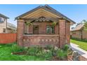 Inviting brick front porch with hanging plants and cozy seating at 2740 N Fillmore St, Denver, CO 80205