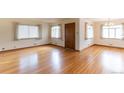 Bright living room featuring gleaming hardwood floors and natural light from multiple windows at 5582 E Colorado Ave, Denver, CO 80222