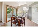 Cozy dining area featuring wood floors, large windows, and space for a table that seats four people at 1310 S Monaco Pkwy # 23, Denver, CO 80224