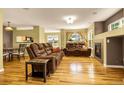Cozy living room with hardwood floors, a gas fireplace, and abundant natural light at 23560 Alamo Pl # B, Aurora, CO 80016