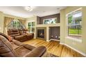 Comfortable living room featuring a fireplace, gleaming hardwood floors and large windows at 23560 Alamo Pl # B, Aurora, CO 80016