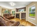 Cozy living room features a fireplace, hardwood floors, and lots of natural light at 23560 Alamo Pl # B, Aurora, CO 80016