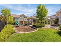 Community playground area with a slide, spring rider, gazebo and mature landscaping at 23560 Alamo Pl # B, Aurora, CO 80016