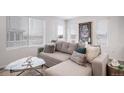 Spacious living room with sectional sofa and large windows at 45032 Sunflower Ln, Bennett, CO 80102