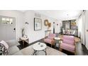 Cozy living room with pink armchairs, modern decor, and open layout at 1402 Meade St, Denver, CO 80204