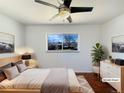 Serene main bedroom featuring hardwood floors, neutral decor, and a bright window at 3268 S Patton Ct, Denver, CO 80236