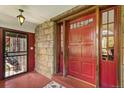 Inviting red front door with glass panels and an ornate security screen at 3520 Newton St, Denver, CO 80211