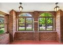 Cozy sunroom with brick walls, arch windows, and bright overhead lighting at 3520 Newton St, Denver, CO 80211