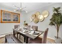 Elegant dining room features modern lighting, a dark wood table, and sophisticated place settings at 2290 E Columbia Pl, Denver, CO 80210