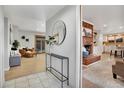 Inviting foyer with a modern console table, round mirror, and a view into the living room and kitchen at 2290 E Columbia Pl, Denver, CO 80210