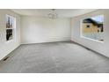 Spacious room with neutral carpeting, abundant natural light, and ample space at 4670 Quandary Peak St, Brighton, CO 80601