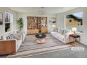 Bright and inviting living room featuring a modern bookcase and stylish decor at 4670 Quandary Peak St, Brighton, CO 80601