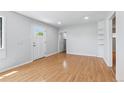 Bright living room featuring hardwood floors and neutral paint, with a view to adjacent rooms at 118 S Yates Way, Denver, CO 80219