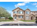 Charming townhome showcases a well-maintained lawn and stone accents, enhancing its curb appeal and welcoming atmosphere at 12798 Ivy St, Thornton, CO 80602