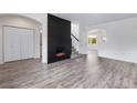 Bright living area with wood floors and a modern fireplace feature, perfect for entertaining or relaxing at 12798 Ivy St, Thornton, CO 80602