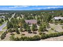 Expansive property showcasing a single-Gathering home amid lush greenery and distant mountain views at 19050 Archers Dr, Monument, CO 80132