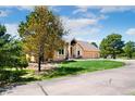 A single-Gathering home with manicured lawn, welcoming front porch, and an attached three-car garage at 19050 Archers Dr, Monument, CO 80132