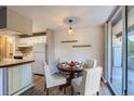 Cozy dining area with a classic round table, stylish chairs, and access to a balcony with natural light at 937 N Clarkson St # 206, Denver, CO 80218