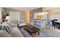 Inviting living room area with a sofa, accent chairs, and bar seating that connects to the kitchen at 937 N Clarkson St # 206, Denver, CO 80218