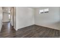 Bright living room showcasing modern hardwood floors and neutral walls, ready for personal touches at 286 Chardon Ave, Brighton, CO 80601