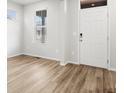 Bright living room boasting natural light, wood-look floors, and neutral paint, creating an inviting space at 22435 E 7Th Pl, Aurora, CO 80018