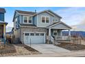 Charming two-story home featuring stone accents, a covered porch, and a two-car garage at 8470 Arriba Dr, Littleton, CO 80125