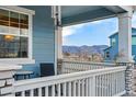 Inviting covered front porch with mountain views, perfect for relaxing outdoors at 8470 Arriba Dr, Littleton, CO 80125