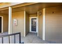 Condo entrance featuring covered porch and exterior light fixture at 6001 S Yosemite St # B207, Greenwood Village, CO 80111