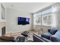 Cozy living room with large windows, fireplace, and modern furniture at 6001 S Yosemite St # B207, Greenwood Village, CO 80111