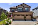 Charming two-story home featuring a three-car garage and landscaped front yard at 7514 Blue Water Dr, Castle Rock, CO 80108