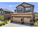 Charming two-story home featuring a three-car garage and landscaped front yard at 7514 Blue Water Dr, Castle Rock, CO 80108