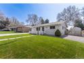 Single-story home boasting a green lawn and close proximity to neighboring houses at 4164 W Eldorado Pl, Denver, CO 80236