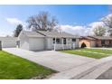 Well-manicured lawn and wide driveway leading to a delightful single-story home at 4164 W Eldorado Pl, Denver, CO 80236