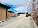 Large backyard with a detached garage and patio space at 2261 W 73Rd Pl, Denver, CO 80221