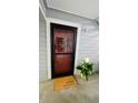Charming front door with decorative wreath, potted plant, and welcome mat at 7665 E Eastman Ave # 110, Denver, CO 80231