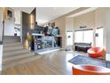 Open living room with fireplace and soaring ceilings, offering abundant natural light and stylish decor at 14058 E Temple Dr, Aurora, CO 80015
