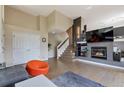 Spacious living room boasting a fireplace, an open floor plan, and a staircase leading to the upper level at 14058 E Temple Dr, Aurora, CO 80015