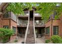 Brick apartment building with trees and stairs leading to the second floor apartments at 832 S Vance St # F, Lakewood, CO 80226