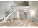 Inviting living room features modern flooring, an open floor plan, and a staircase to the second level at 832 S Vance St # F, Lakewood, CO 80226