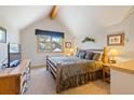 Cozy bedroom with vaulted ceiling, wood accents, and comfortable bed at 33 Broken Lance Dr # 207S, Breckenridge, CO 80424