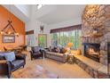 Inviting living room featuring a stone fireplace, comfortable seating, and large windows offering scenic views at 33 Broken Lance Dr # 207S, Breckenridge, CO 80424