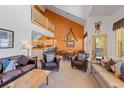 Bright living room with vaulted ceilings, leather furniture, and an open floor plan to kitchen and dining area at 33 Broken Lance Dr # 207S, Breckenridge, CO 80424