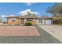 Charming single-story home with brick and siding, a well-manicured lawn, and a two-car garage at 180 W 78Th Pl, Denver, CO 80221