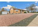 Charming brick home featuring a well-maintained exterior, low maintenance landscaping, and a detached garage at 180 W 78Th Pl, Denver, CO 80221
