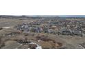 Expansive aerial view of a well-planned community surrounded by natural landscapes and rolling hills at 2578 Gray Wolf Pl, Castle Rock, CO 80104