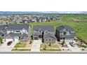 Suburban neighborhood featuring manicured lawns and sidewalks with easy access to nearby green spaces and roadways at 671 Green Mountain Dr, Erie, CO 80516
